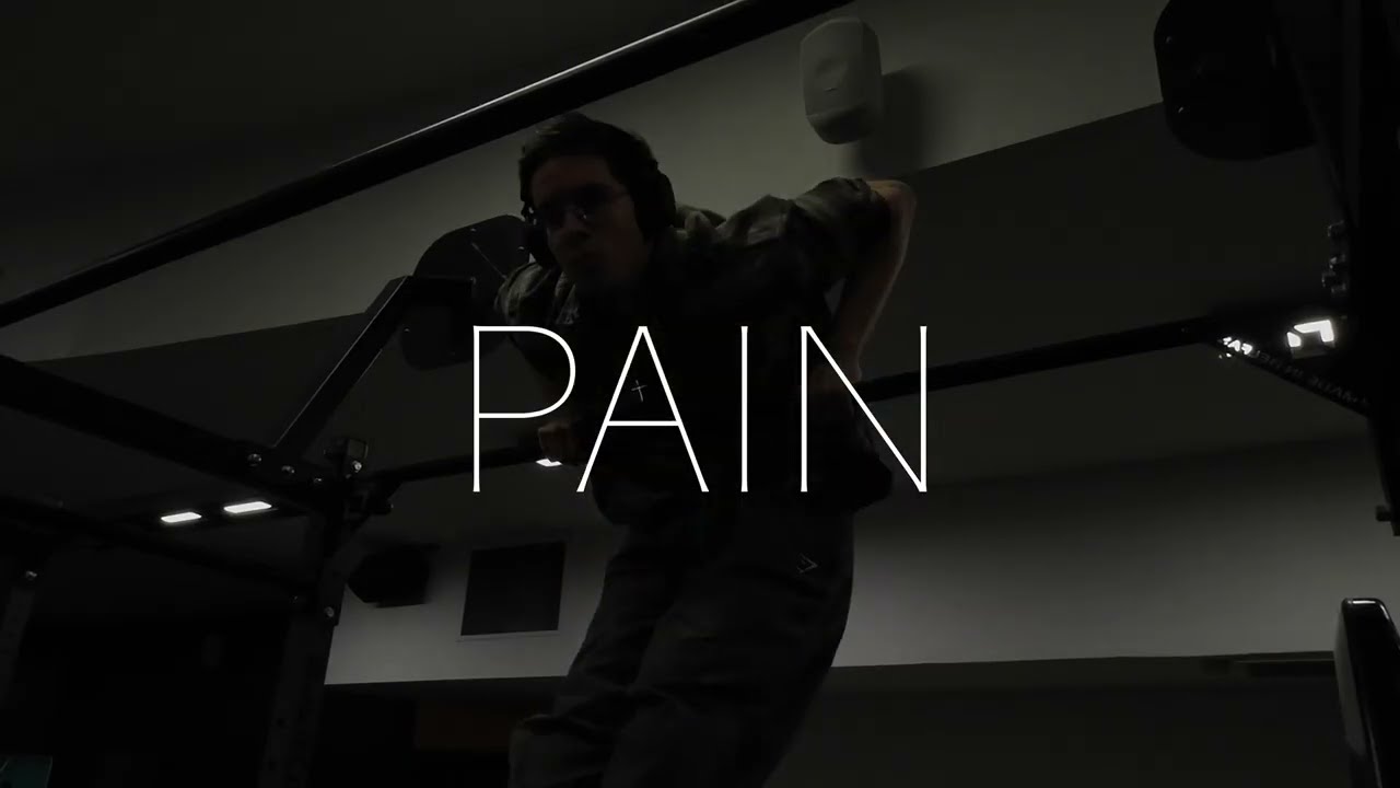 Moody gym edit with the word PAIN over a lifter on parallel bars